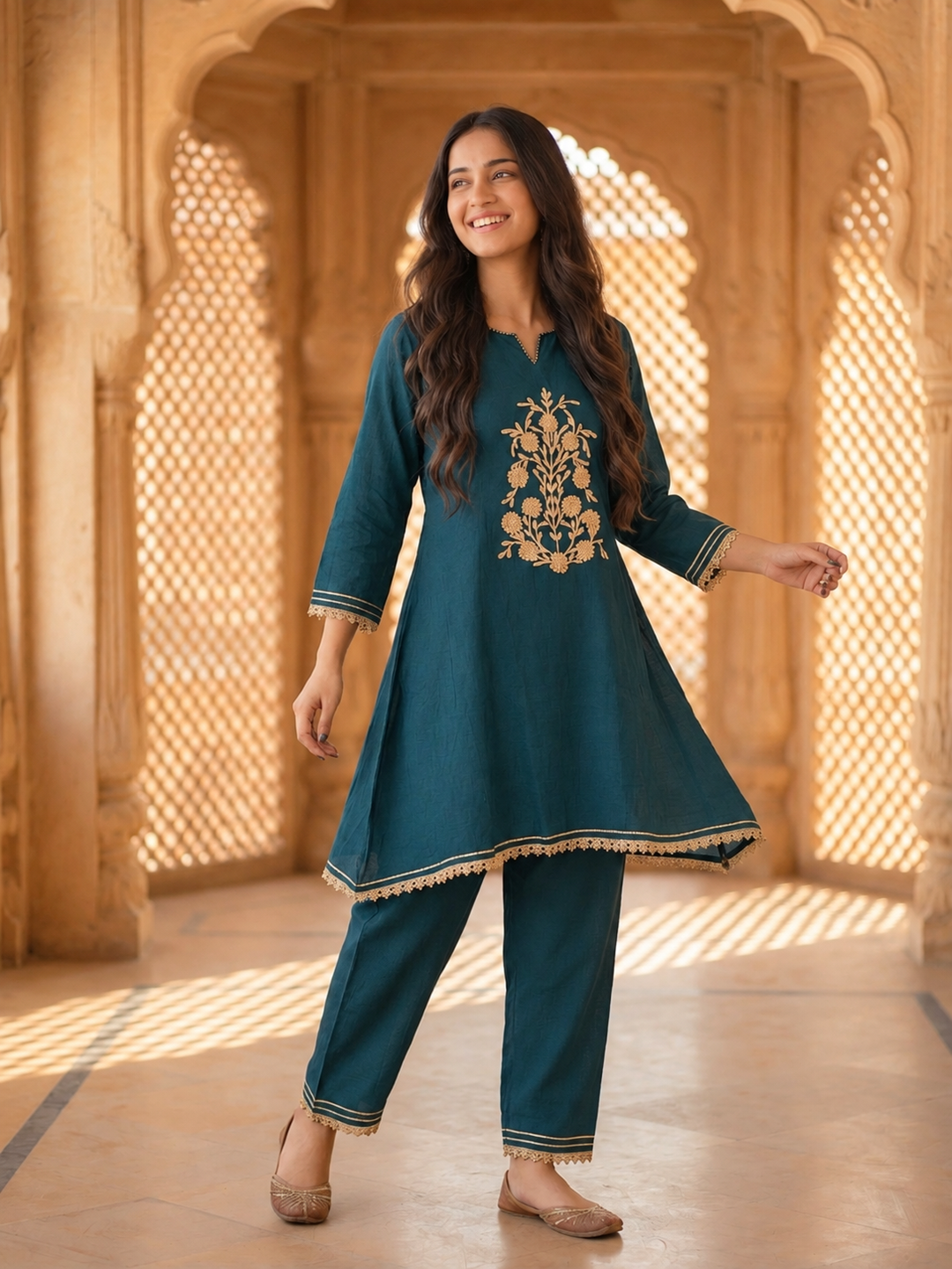 Profile view of teal blue embroidered A-line kurta set