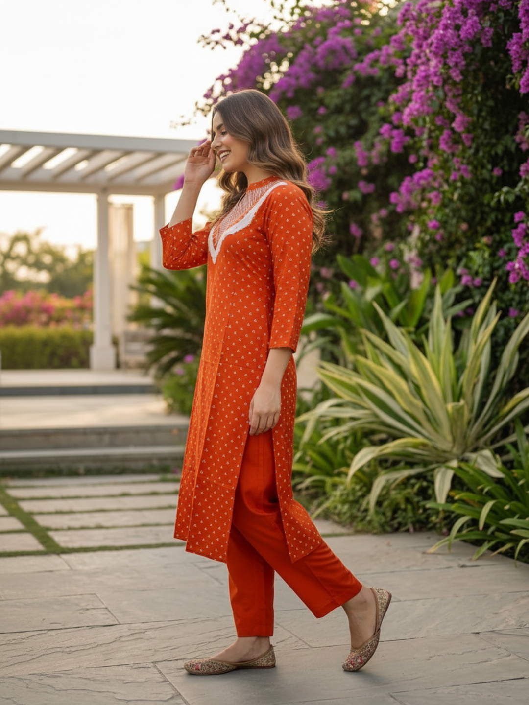 Detail of rust orange Bandhani print cotton kurta and neckline