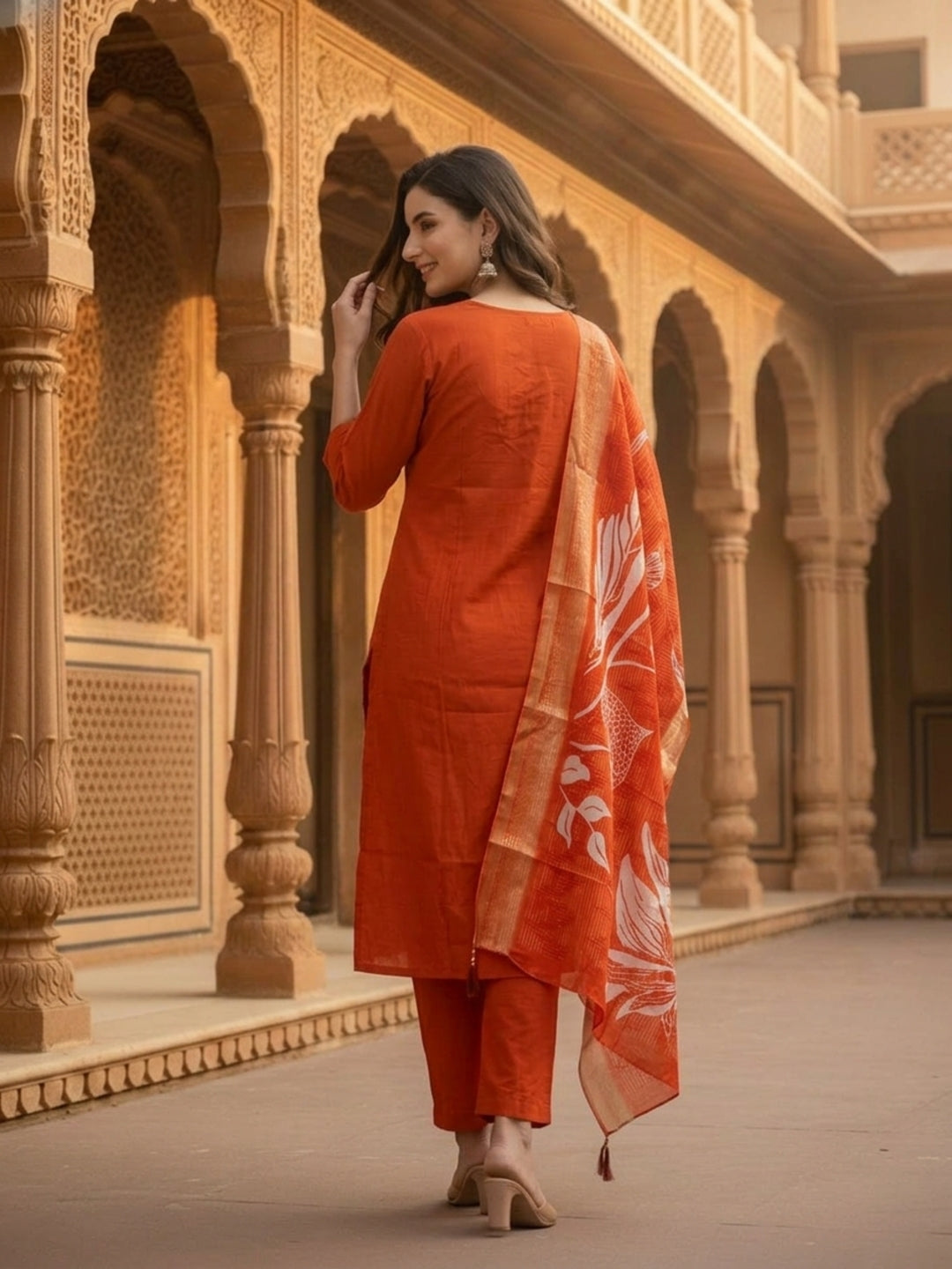 Rust Solid Muslin Silk Straight Kurta Set with Pearl & Threadwork Embroidery, Round Neck, Trouser & Poly Chanderi Self Design Tassel Dupatta