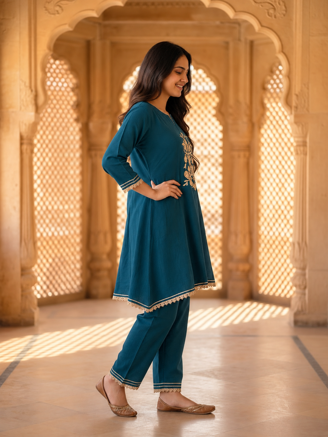 Model wearing teal blue embroidered kurta set with matching dupatta