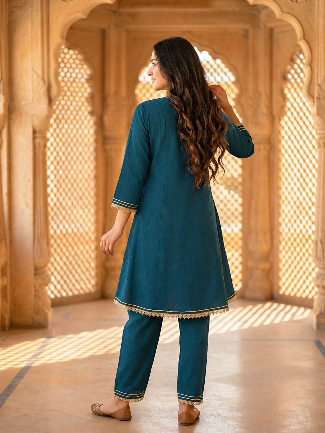 Front view of teal blue solid A-line kurta set
