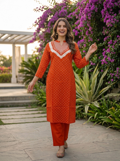 Model wearing rust orange Bandhani print cotton kurta with trousers and dupatta