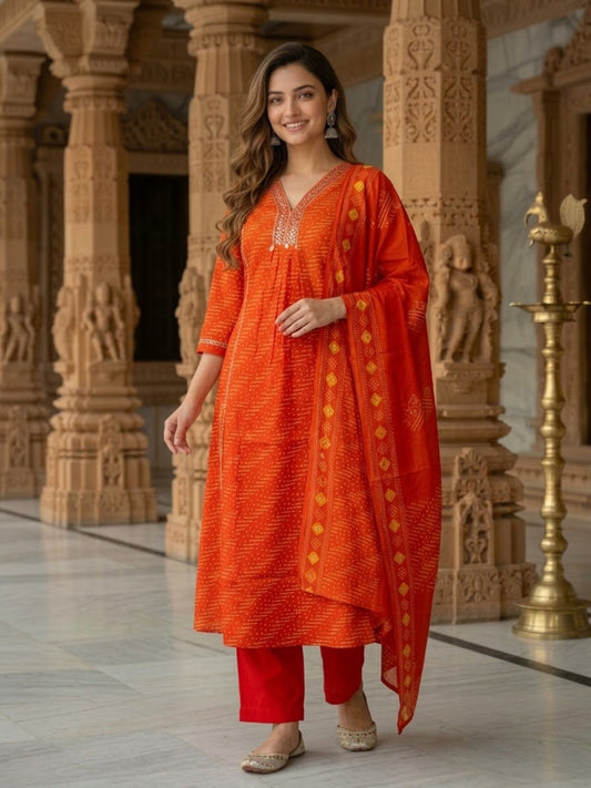 Front view of rust Bandhani-print kurta set with trousers and printed dupatta