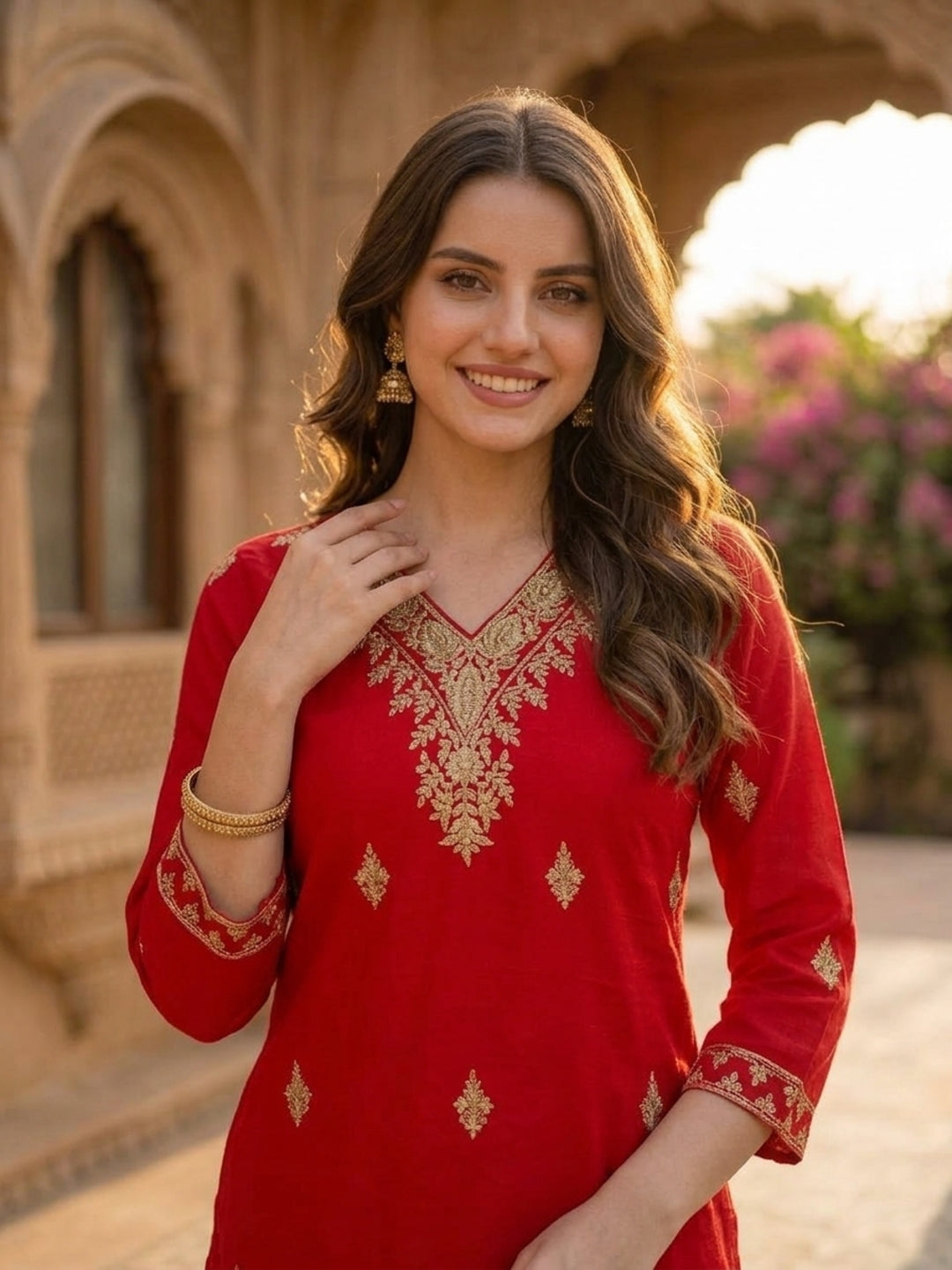 Close-up of ethnic embroidery at the V-neck of the red silk kurta