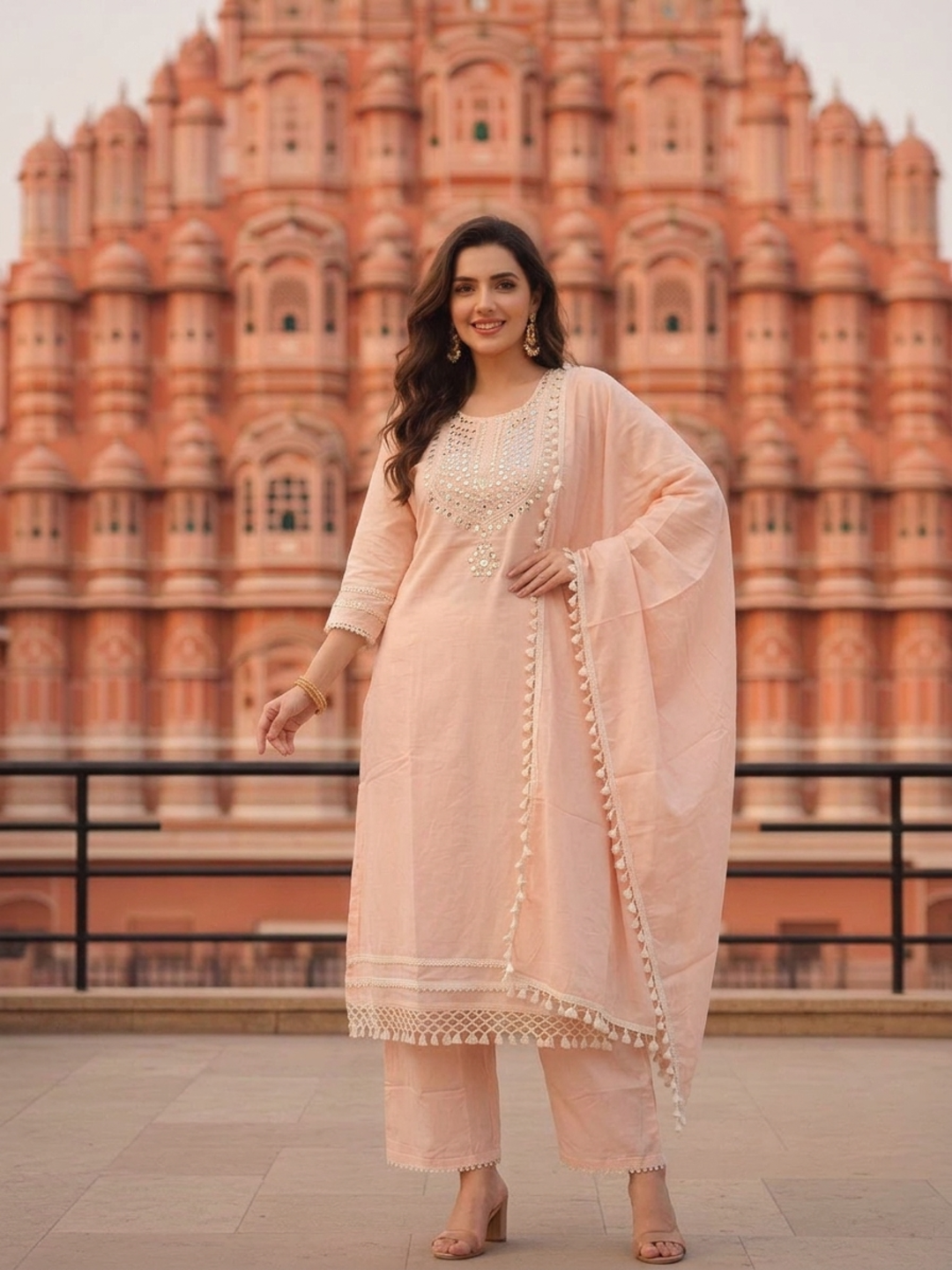 Model wearing the peach mirror work kurta set with palazzos and dupatta