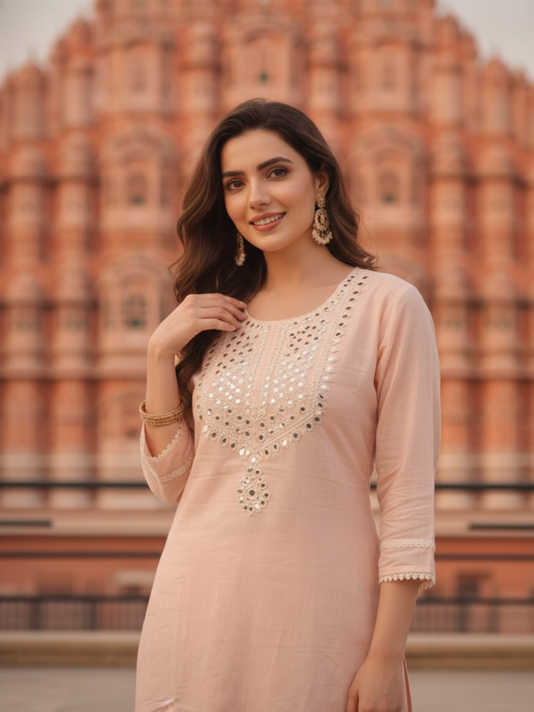 Close-up of mirror work on the peach kurta yoke